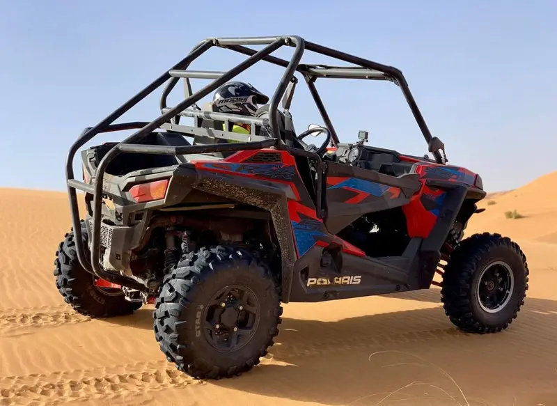 Buggy biplace avec arceau de sécurité et pneus crantés sur le sable du désert de Merzouga