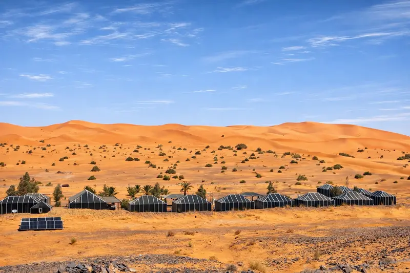 Tassili camp seen from the top of a dune, with the Merzouga desert all around