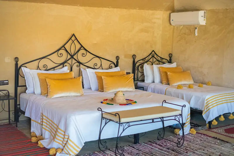 Triple tent with three beds made up, a Berber rug and air conditioning