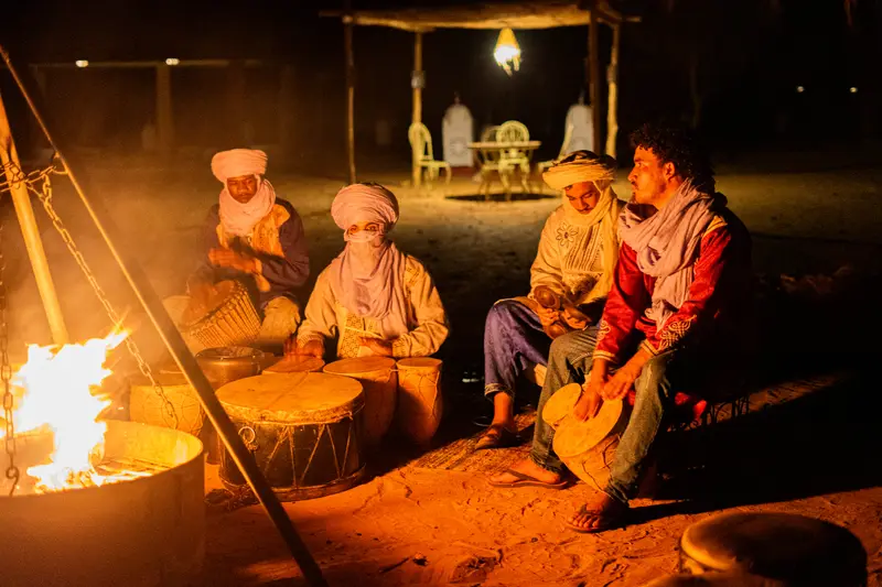 Berber musicians playing the drums by the fire, after dinner